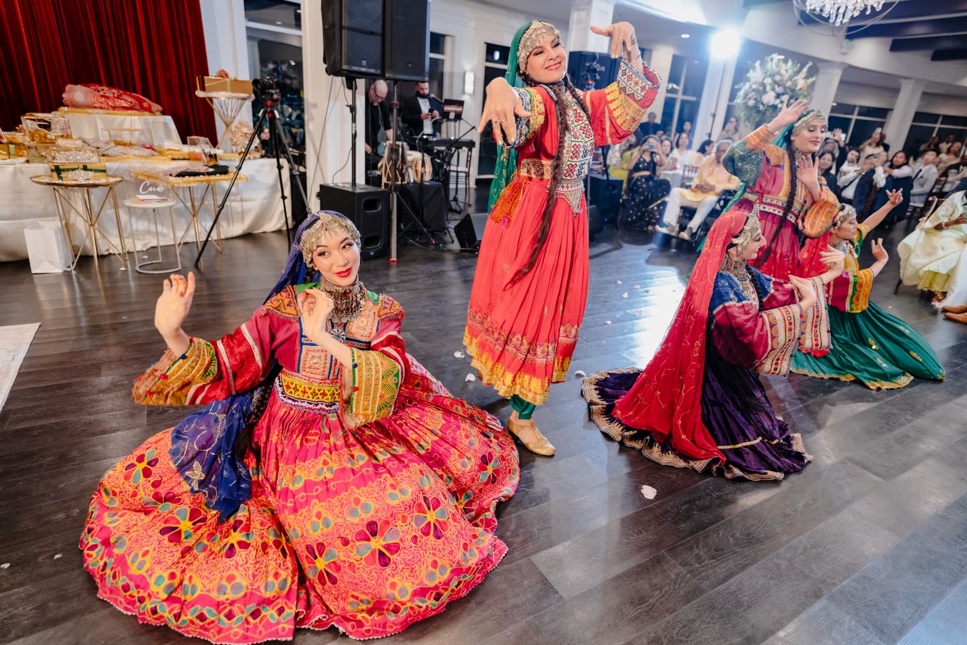 Dancers kneeling with skirts spread in a circle